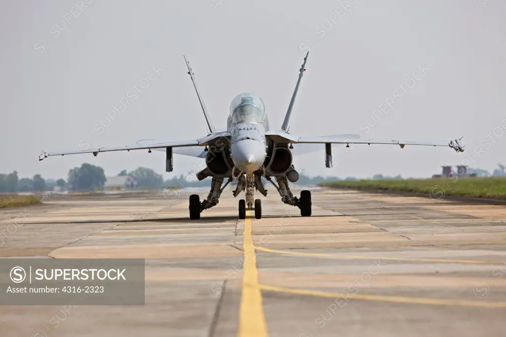 A United States Marine Corps F/A-18D taxis along a flight line at Kuantan Air Base, Malaysia.