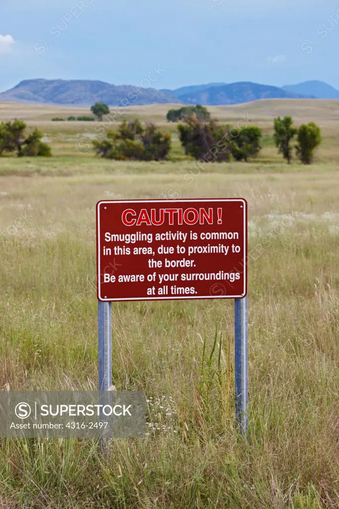 A sign warns of smuggling along the United States - Mexico Border, near Lochiel, Arizona, near the town of Patagonia