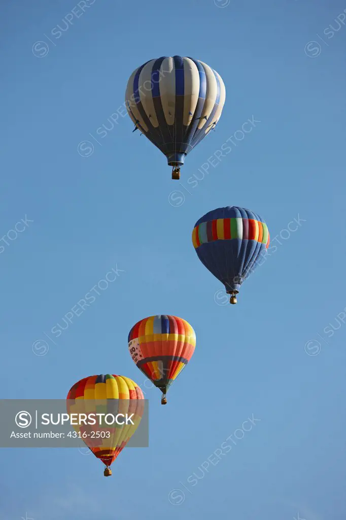 Hot air balloons aloft in the morning sky above Reno, Nevada, during the Reno Balloon Races.