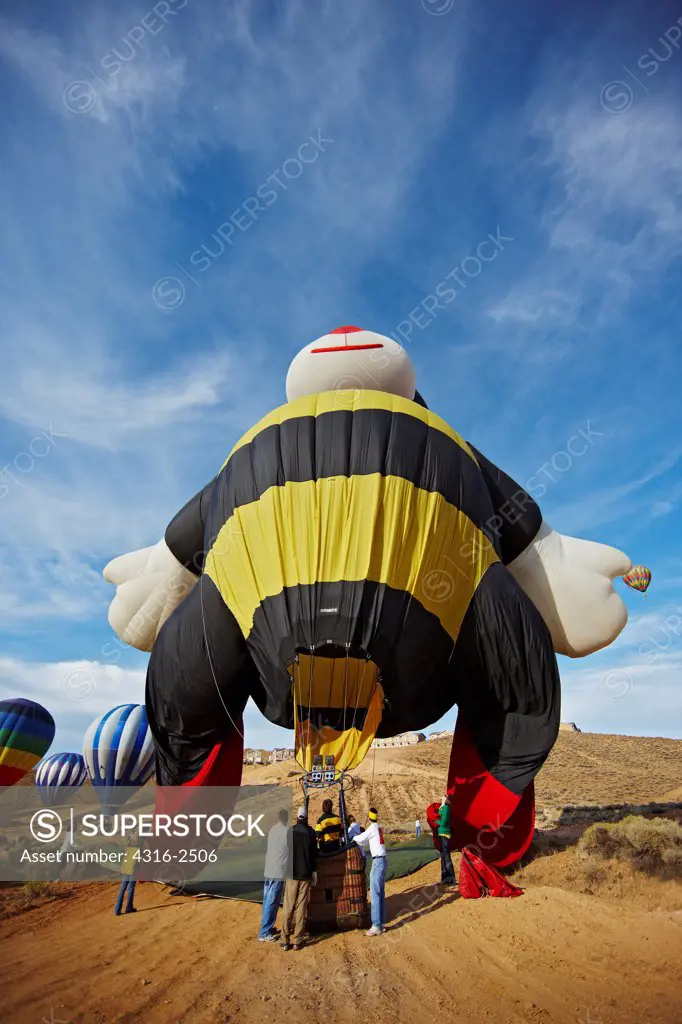A bee shaped balloon deflating after a successful flight at the Reno Balloon Races, Reno, Nevada.