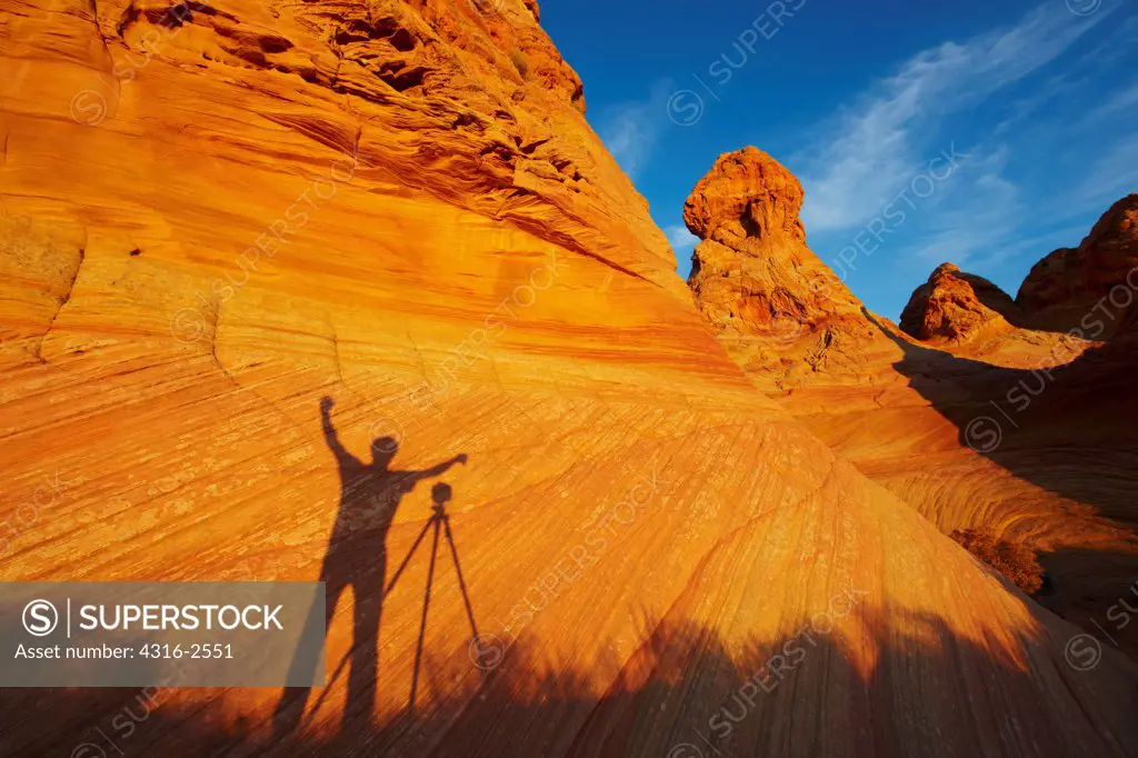 The shadow of a photographer on a sandstone formation, South Coyote Buttes, Paria Canyon-Vermilion Cliffs Wilderness area.