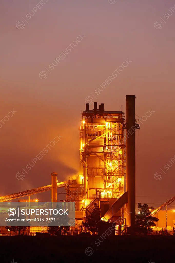 Dusk view of a cement factory in Woodland, California.