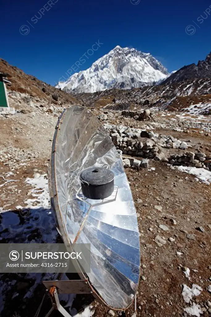 A parabolic solar water heater heats a bowl of water at Lobuche, Nepal, in the Mount Everest region.