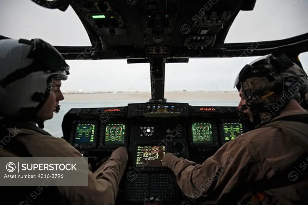 U.S. Marine Corps aviators in the cockpit of an MV-22 Osprey during a combat operation in southern Afghanistan's Helmand Province.