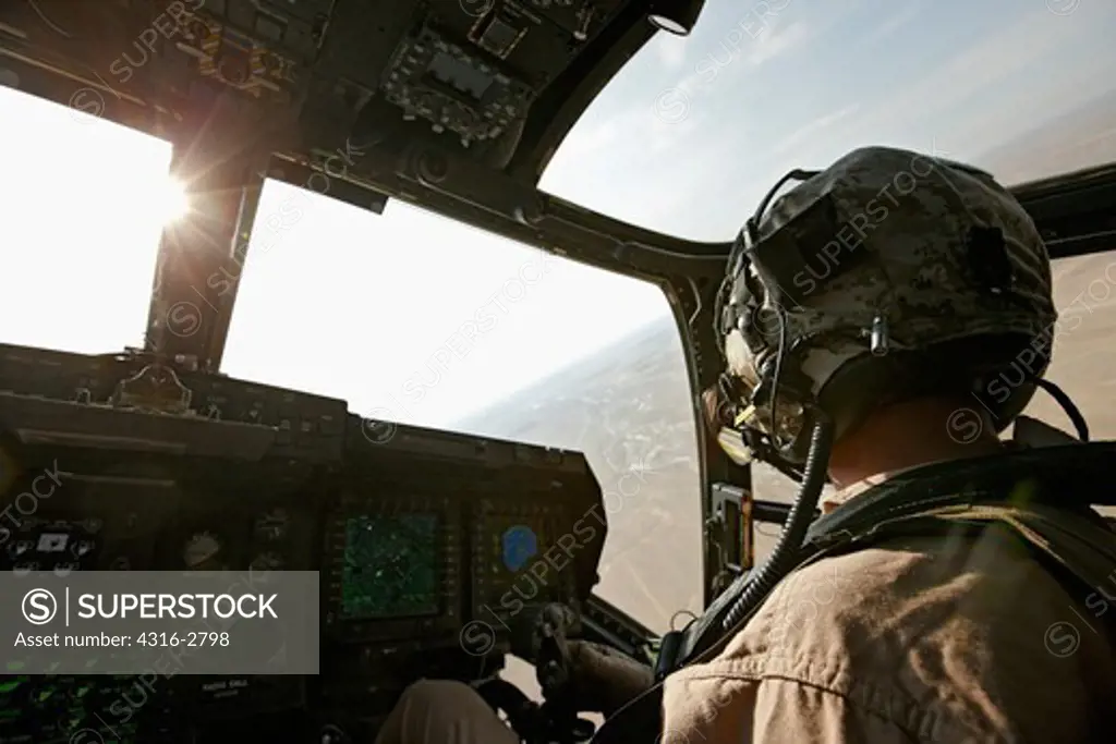 A U.S. Marine Corps aviator in the cockpit of an MV-22 Osprey during a combat operation in southern Afghanistan's Helmand Province.