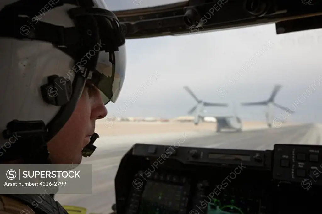 U.S. Marine Corps aviator prepares to launch an MV-22 Osprey taxiing behind another Osprey at Camp Bastion, Helmand Province, Afghanistan.