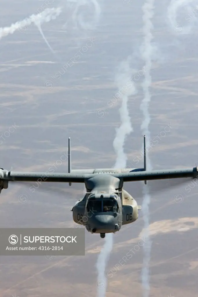A U.S. Marine Corps MV-22 Osprey expends flares during a combat operation over the Helmand Province of southern Afghanistan.