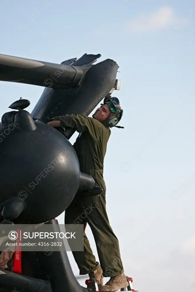 A U.S. Marine Corps aircraft maintainer works on the proprotor assembly on one of two engines of an MV-22 Osprey at Camp Bastion, Helmand Province, Afghanistan.