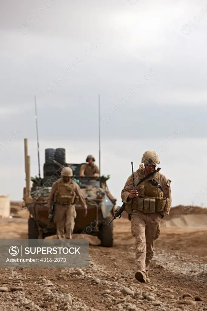 U.S. Marines guide an LAV-25 Light Armored Vehicle at a combat outpost in Afghanistan's southern Helmand Province.