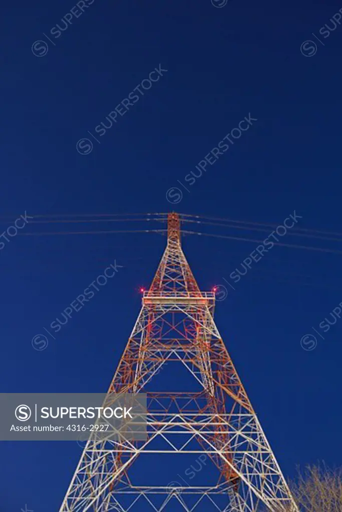 Night view of a high voltage power line tower on the bank of the Mobile River, Mobile, Alabama.