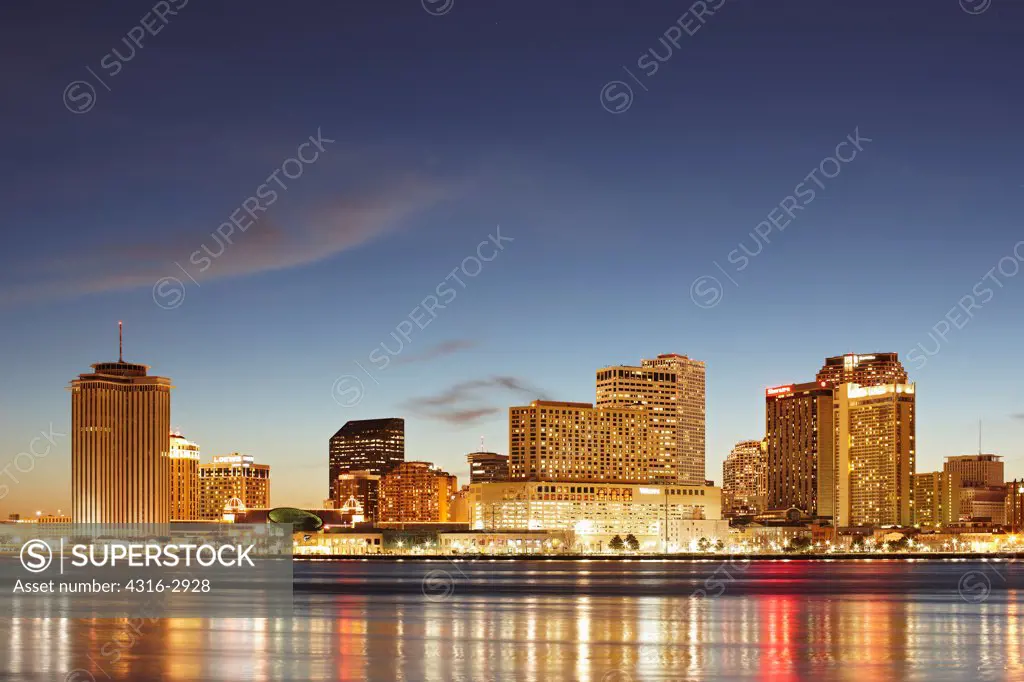 Dusk view of high rise buildings of New Orleans, Louisiana and the Mississippi River, as seen from the Algiers Point Section of New Orleans, Louisiana.
