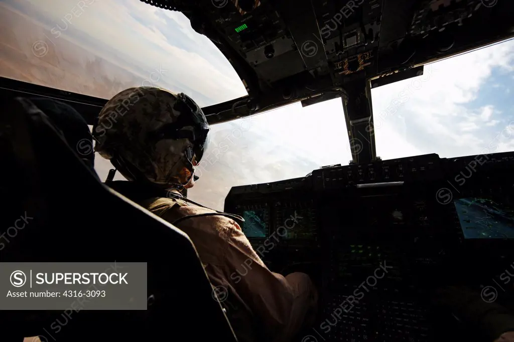 U.S. Marine Corps aviator in the cockpit of an MV-22 Osprey, Helmand Province, Afghanistan, steeply banking the Osprey.