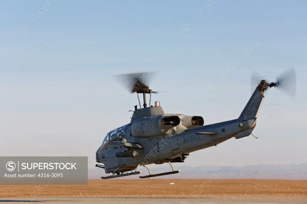 A U.S. Marine Corps AH-1W Super Cobra launches from Camp Bastion, Helmand Province, southern Afghanistan.