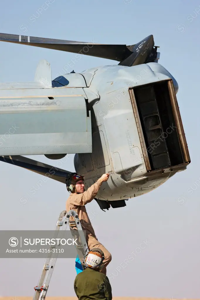 U.S. Marine Corps aviation maintainers work on one of two nacelles of an MV-22 Osprey at Camp Bastion, Helmand Province, southern Afghanistan.