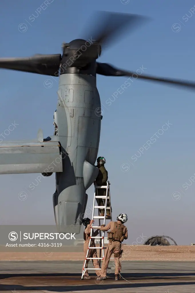 U.S. Marine Corps aircraft maintainers work on an engine of an MV-22 Osprey at Camp Bastion, Helmand Province, Southern Afghanistan.