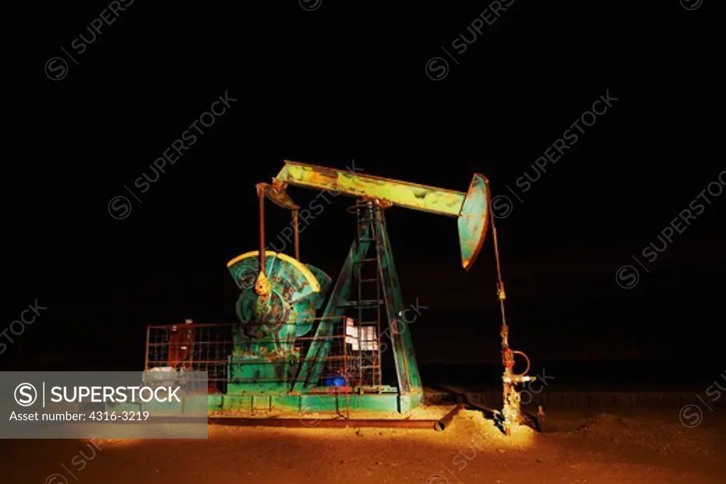 A night view of an oil well pump, or pumpjack, near Dacano, Colorado.