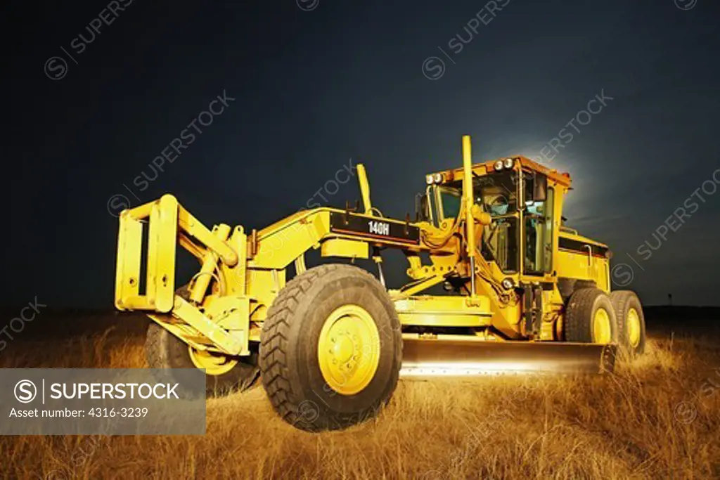 A night view of a grader, also known as a road grader, Weld County, Colorado, in the Pawnee National Grasslands.