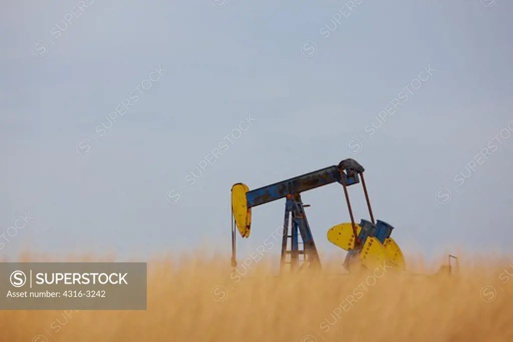 A pumpjack at an oil well in the grasslands of Weld County, Eastern Colorado.