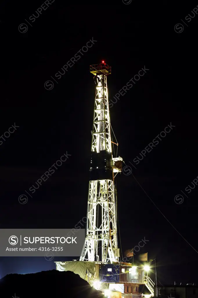 A natural gas well drill rig at night on Colorado's eastern plains.