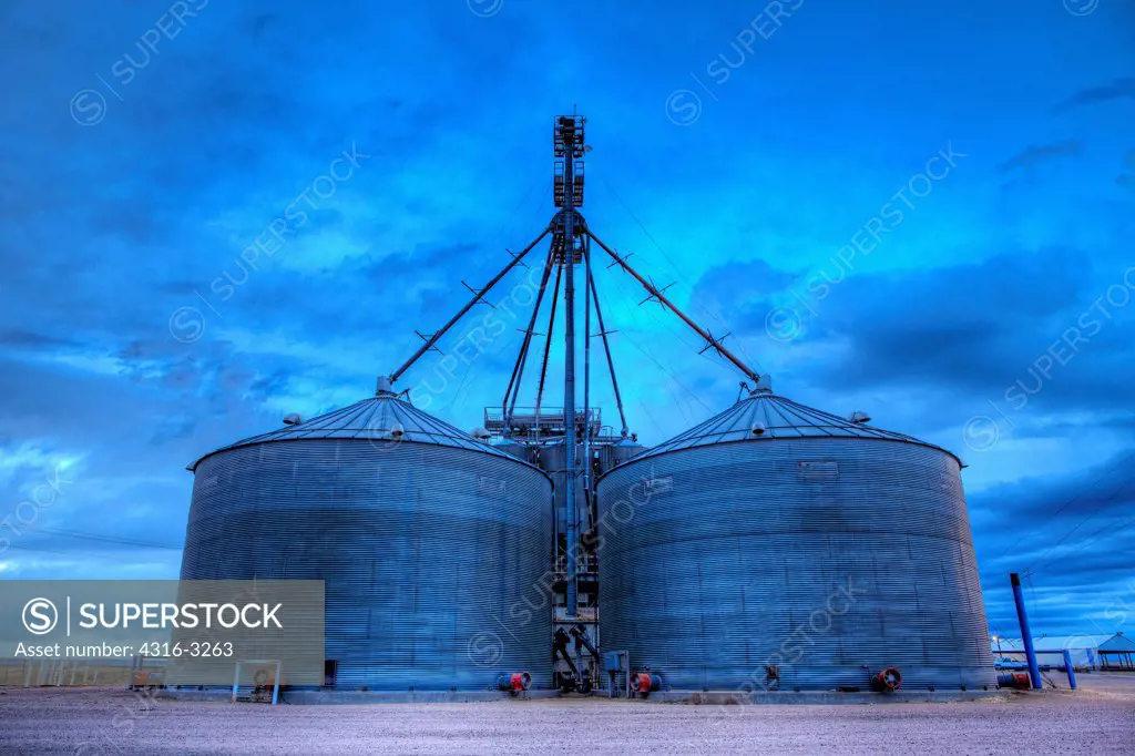 Corrugated steel grain storage bins used to store grain feed for cattle at a beef cattle feedlot, Wellington, Colorado, in an HDR, or high dynamic range image.