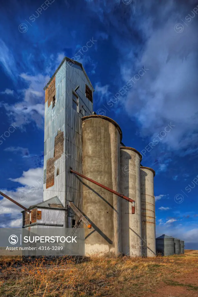 Abandoned grain elevator and grain silos at the ghost town of Willard, in Colorado's eastern plains, in a High Dynamic Range, or HDR view.