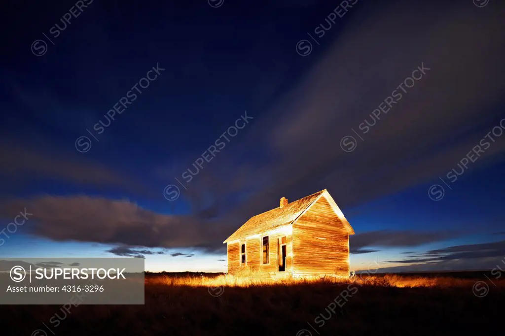 A night view of a Dust Bowl-era abandoned school house at the site of Buckingham Ghost Town, on the eastern plains of Colorado.