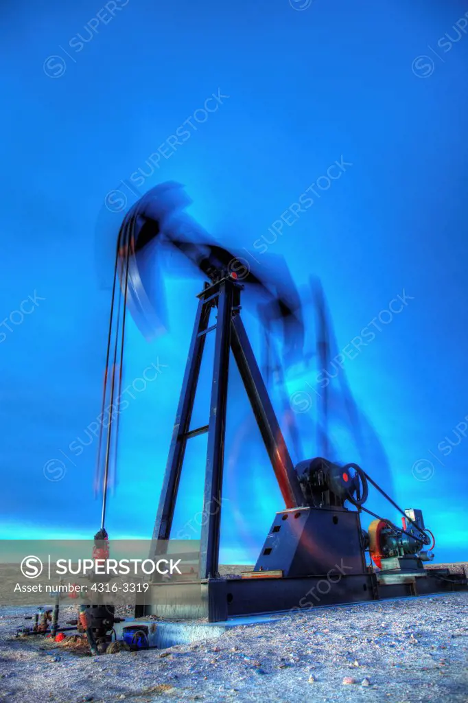 A high dynamic range, or HDR, image of an oil well pump jack in northeastern Colorado, showing motion of the pump, the end known as the 'horsehead' (left side), walking beam, crank, and counterweight. A pump jack is also known as a pumpjack, a pumping unit, a grasshopper pump, and a jack pump, among other names.