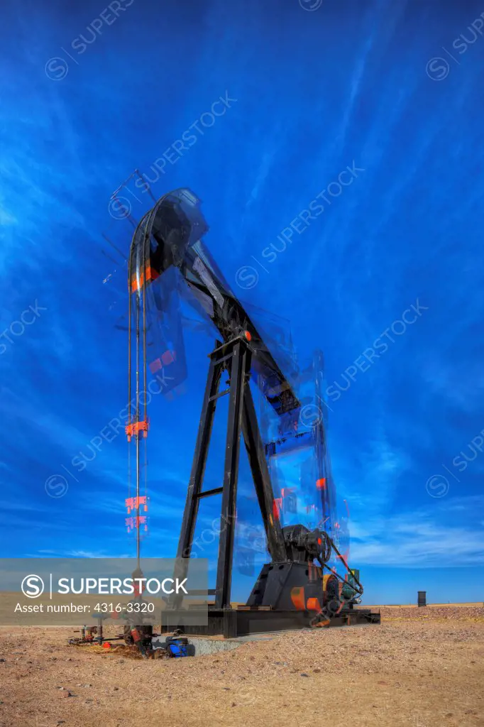 A high dynamic range, or HDR, image of an oil well pump jack in northeastern Colorado, showing motion of the pump, the end known as the 'horsehead' (left side), walking beam, crank, and counterweight. A pump jack is also known as a pumpjack, a pumping unit, a grasshopper pump, and a jack pump, among other names.