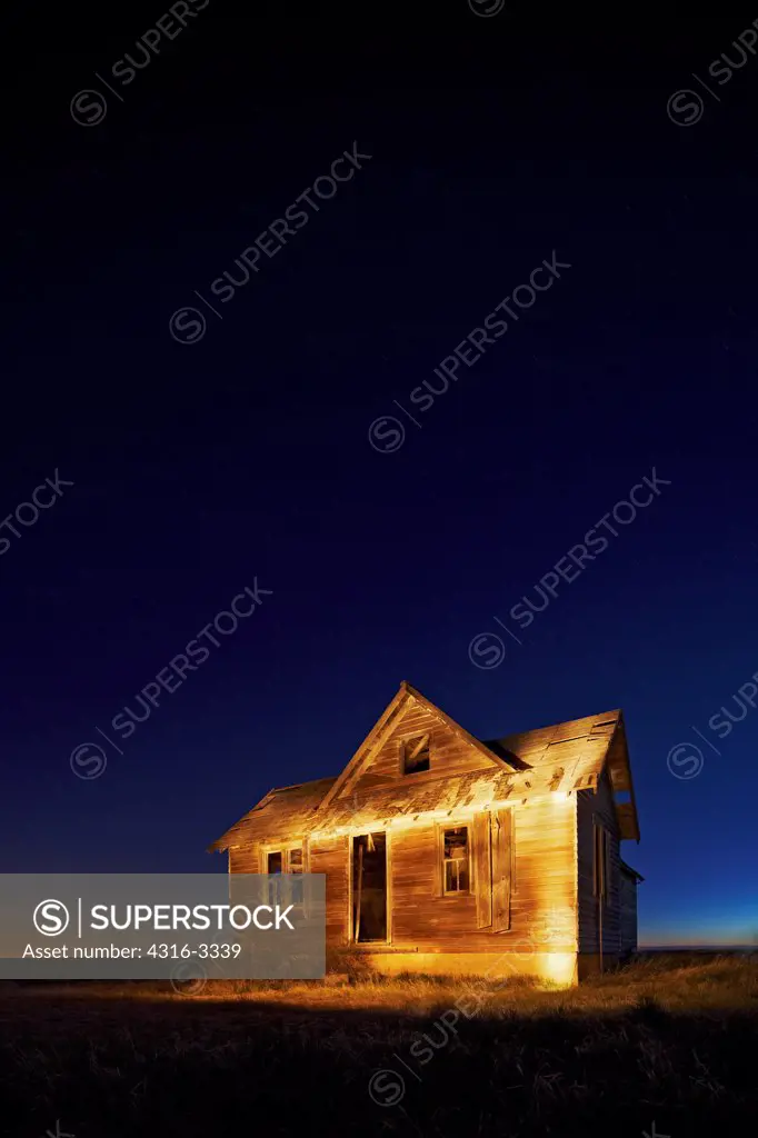 Night view of an abandoned farm house in Colorado's eastern plains.