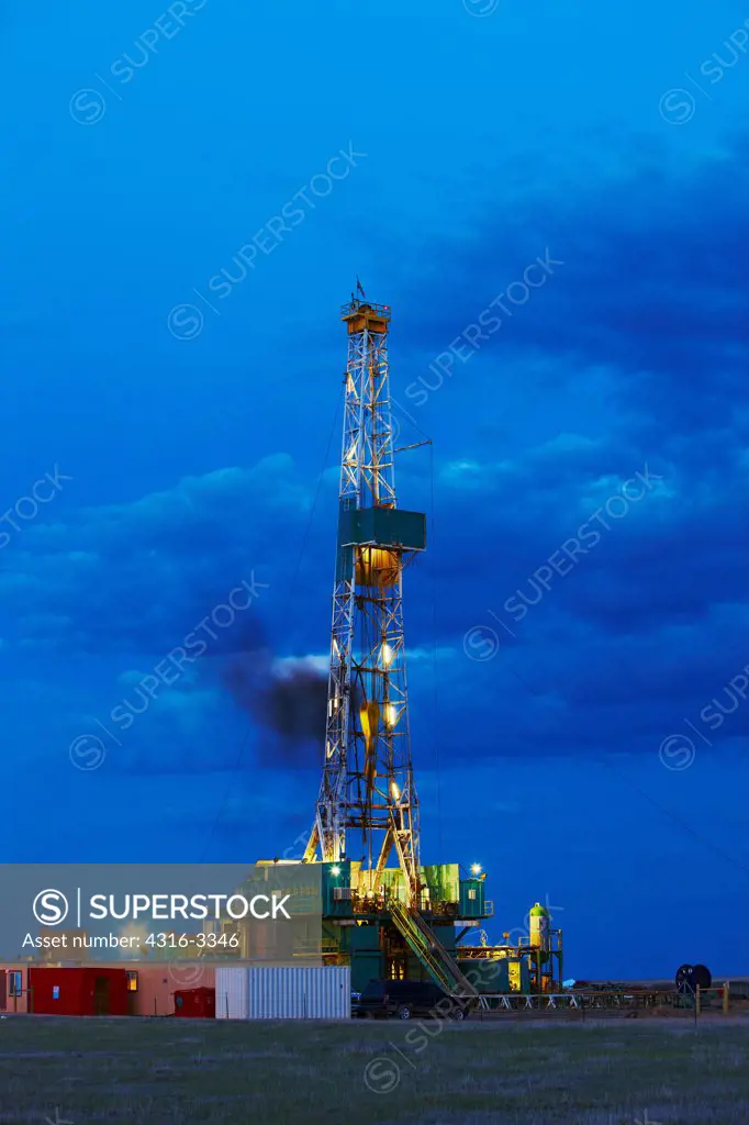 Hydraulic fracturing natural gas drilling rig at dusk, in the eastern Colorado plains.