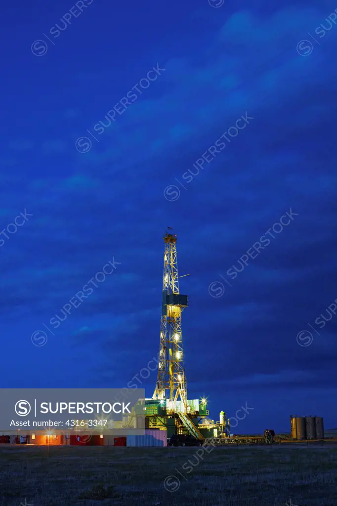 Hydraulic fracturing natural gas drilling rig at dusk, in the eastern Colorado plains. High Dynamic Range, or HDR, view.
