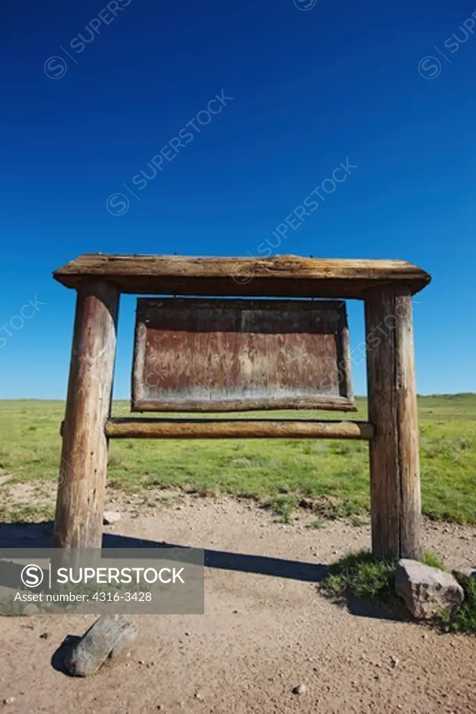 A sign, weathered by the sun, wind, rain, and snow, in Colorado's Pawnee National Grasslands.