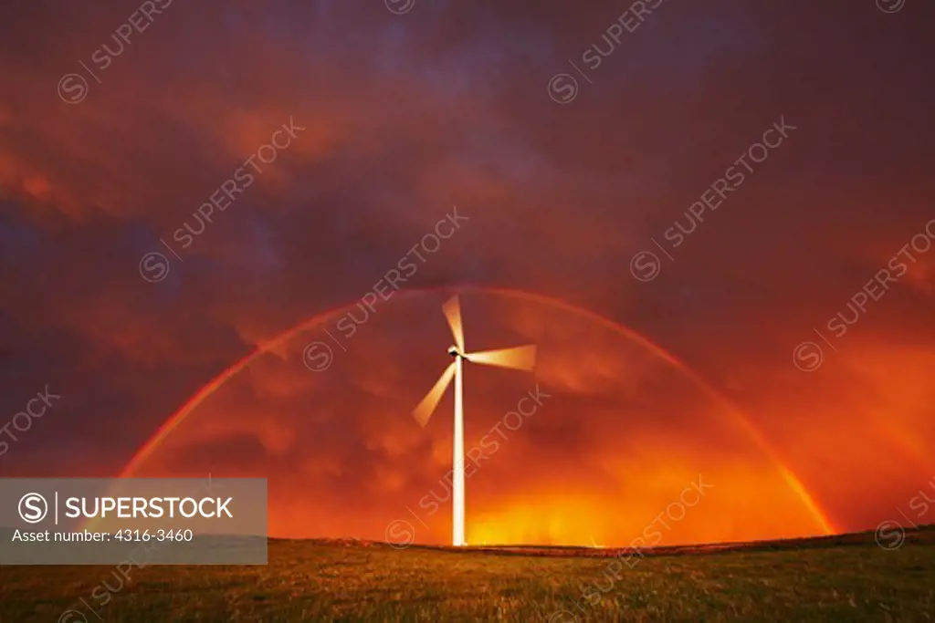Wind turbine framed by a double rainbow after a passing powerful thunderstorm.