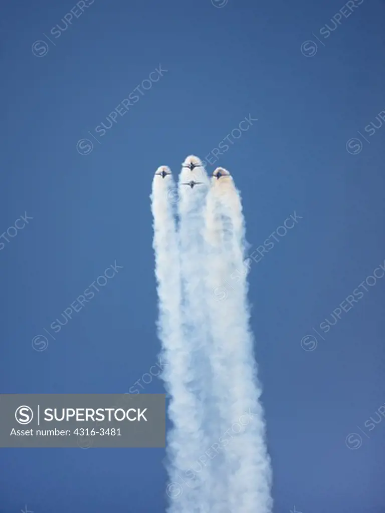 Air Force Thunderbirds demonstration team F-16 Fighting Falcons performing a loop in tight formation.