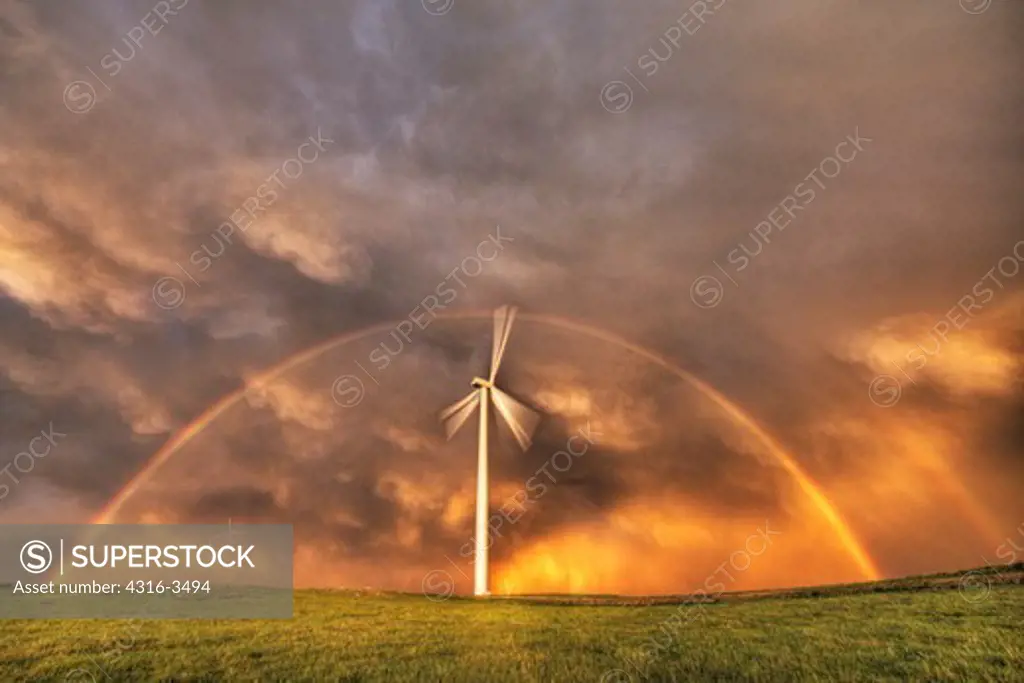 Double rainbow over wind turbine at wind farm, high dynamic range, or HDR image.