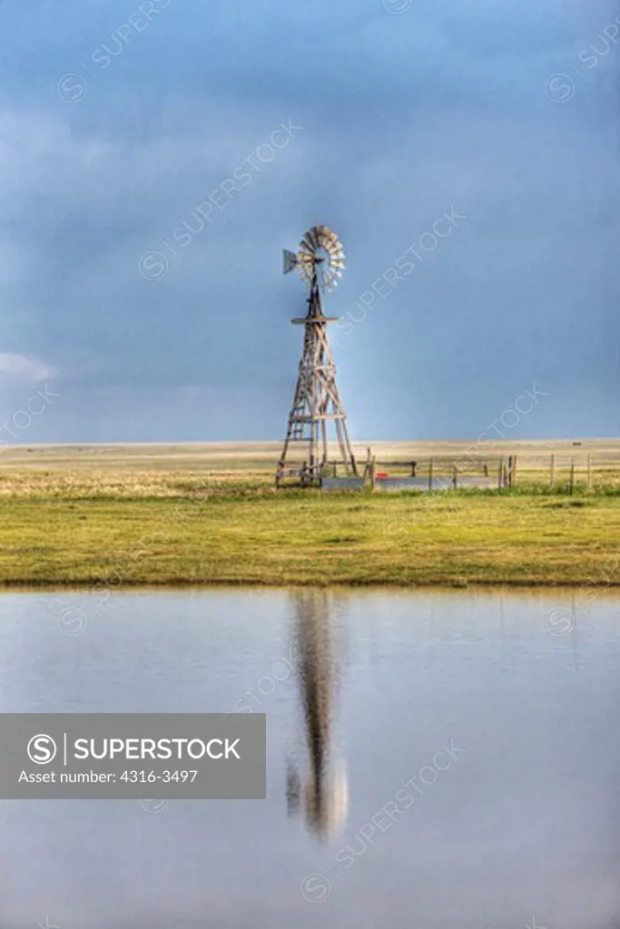 Windmill and reflection in pond, high dynamic range, or HDR image.