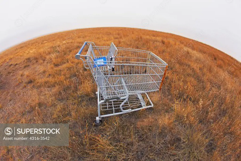 A shopping cart abandoned on the prairie of Colorado's eastern plains, High Dynamic Range, or HDR, Image, fisheye view.
