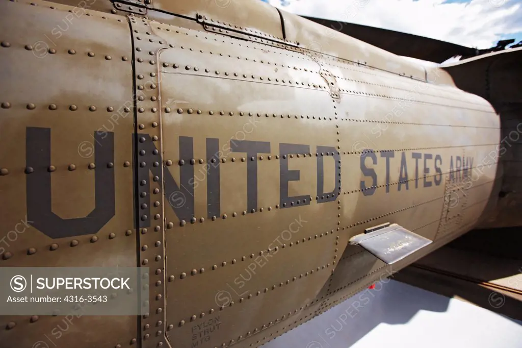 Detail view of a tail of a U.S. Army UH-60 Blackhawk helicopter, showing rivets and United States Army stencil.