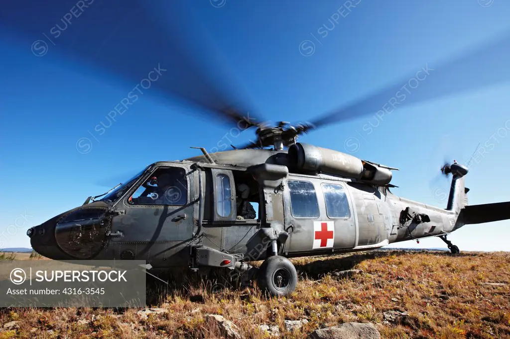 A U.S. Army UH-60 Blackhawk helicopter, configured for air ambulance medevac, at a high altitude mountain landing zone in Colorado, during training for high density altitude flying.
