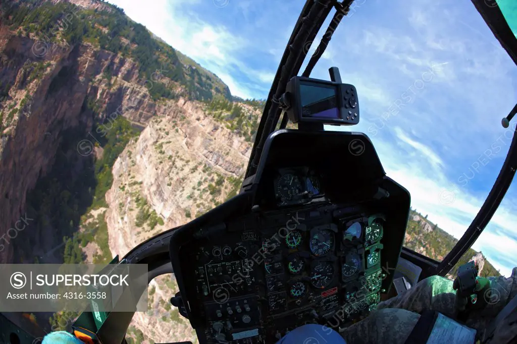 Cockpit view of a deep canyon in Colorado's Rocky Mountains, from Bell OH-58 Kiowa.