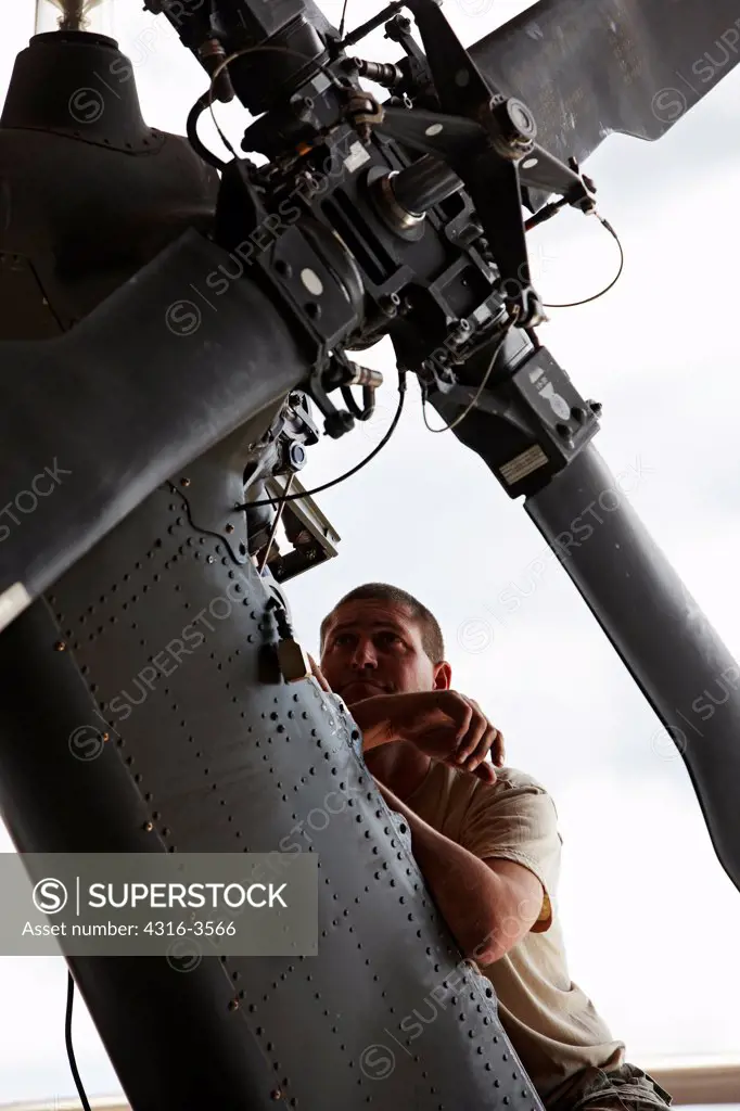 An aircraft maintainer at HAATS, or the High Altitude Army National Guard Training Site, works on a tail rotor assembly of a Sikorsky UH-60 Blackhawk.