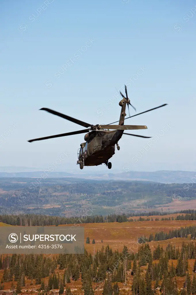A Sikorsky UH-60 Blackhawk helicopter above Colorado's Rocky Mountains.