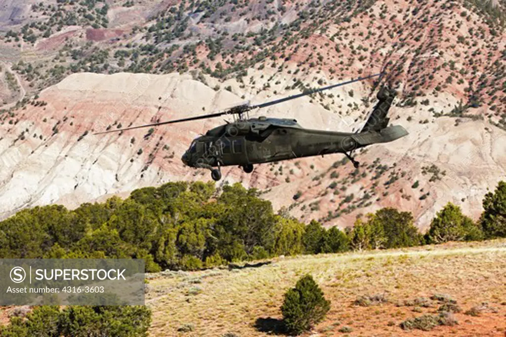 A UH-60 Blackhawk helicopter launches from a high altitude landing zone in Colorado's Rocky Mountains.