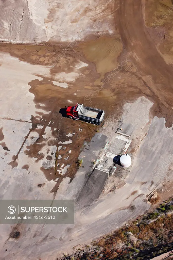 Aerial view of a dump truck in a gravel quarry.