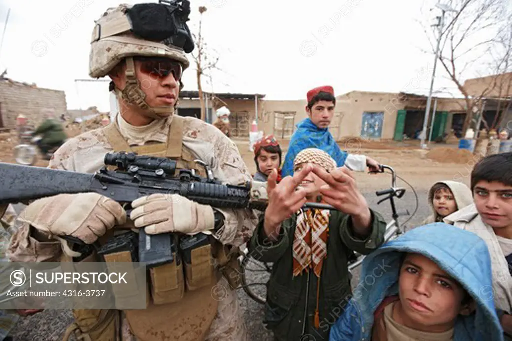 U.S. Marine With Local Children in Marjah, Afghanistan.