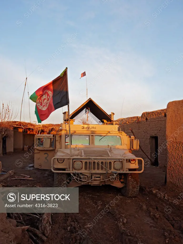 Afghan National Police HUMVEE Flying the Flag of Afghanistan, Parked at a Remote, Austere Combat Outpost in Afghanistan's Helmand Province