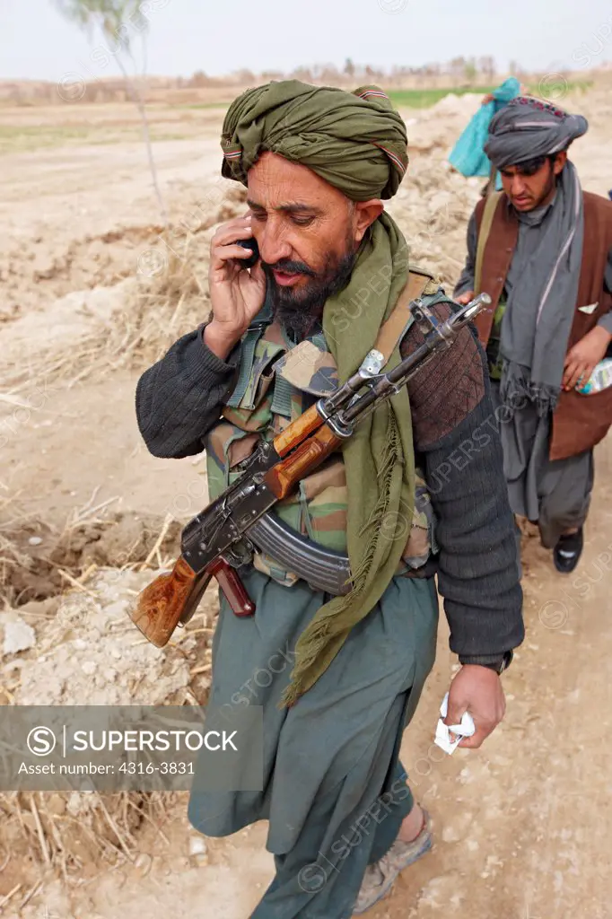A Militia Member Speaks on a Cellular Phone During a Combat Operation in Afghanistan's Helmand Province
