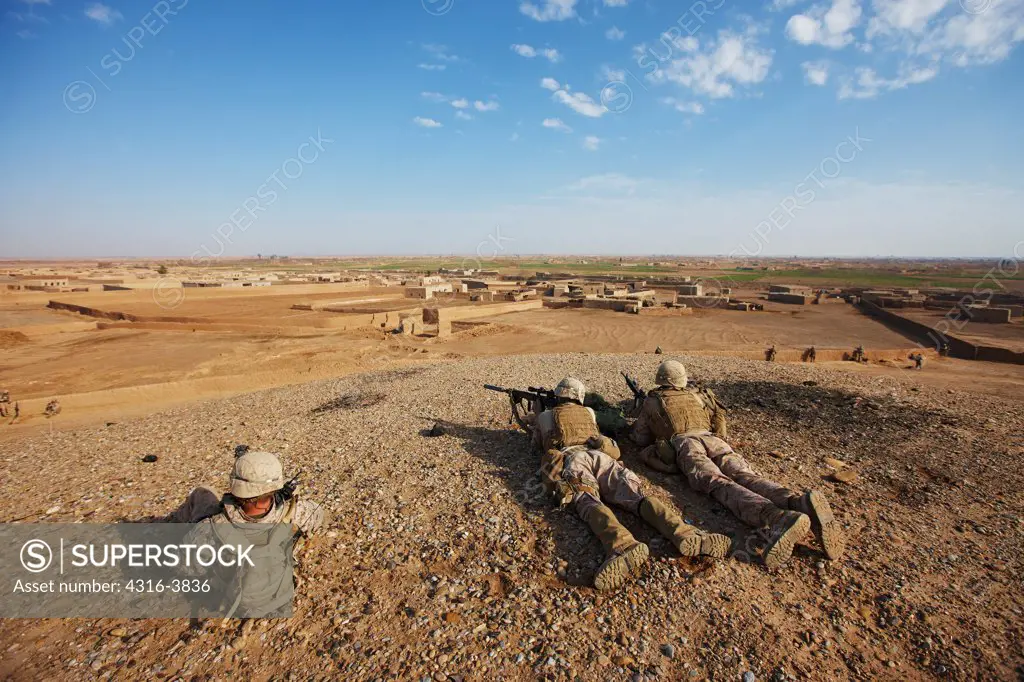 U.S. Marine Corps Designated Marksmen Overlook a Town in Afghanistan's Helmand Province During a Combat Operation
