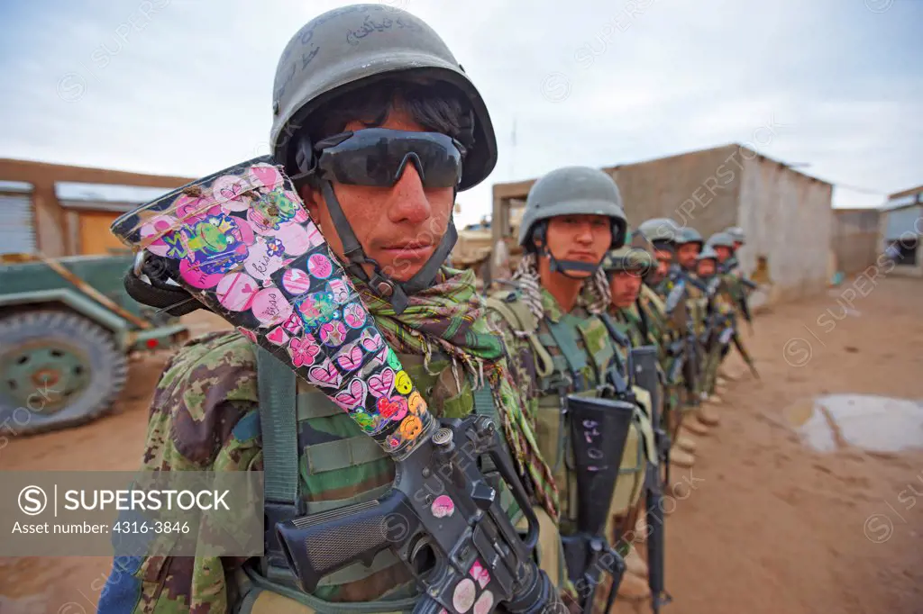 Afghan National Army Soldier in a Line of Soldiers Displays a U.S. Supplied M16 Rifle Adorned With Childish Colorful Stickers at a Remote, Austere Combat Outpost in Afghanistan's Helmand Province