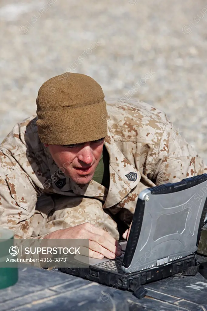 A U.S. Marine Works on A Ruggedized Laptop Computer in Afghanistan's Helmand Province